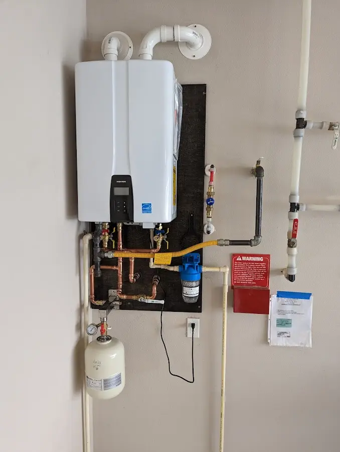 Professional plumber installing copper piping in a Wawayanda home